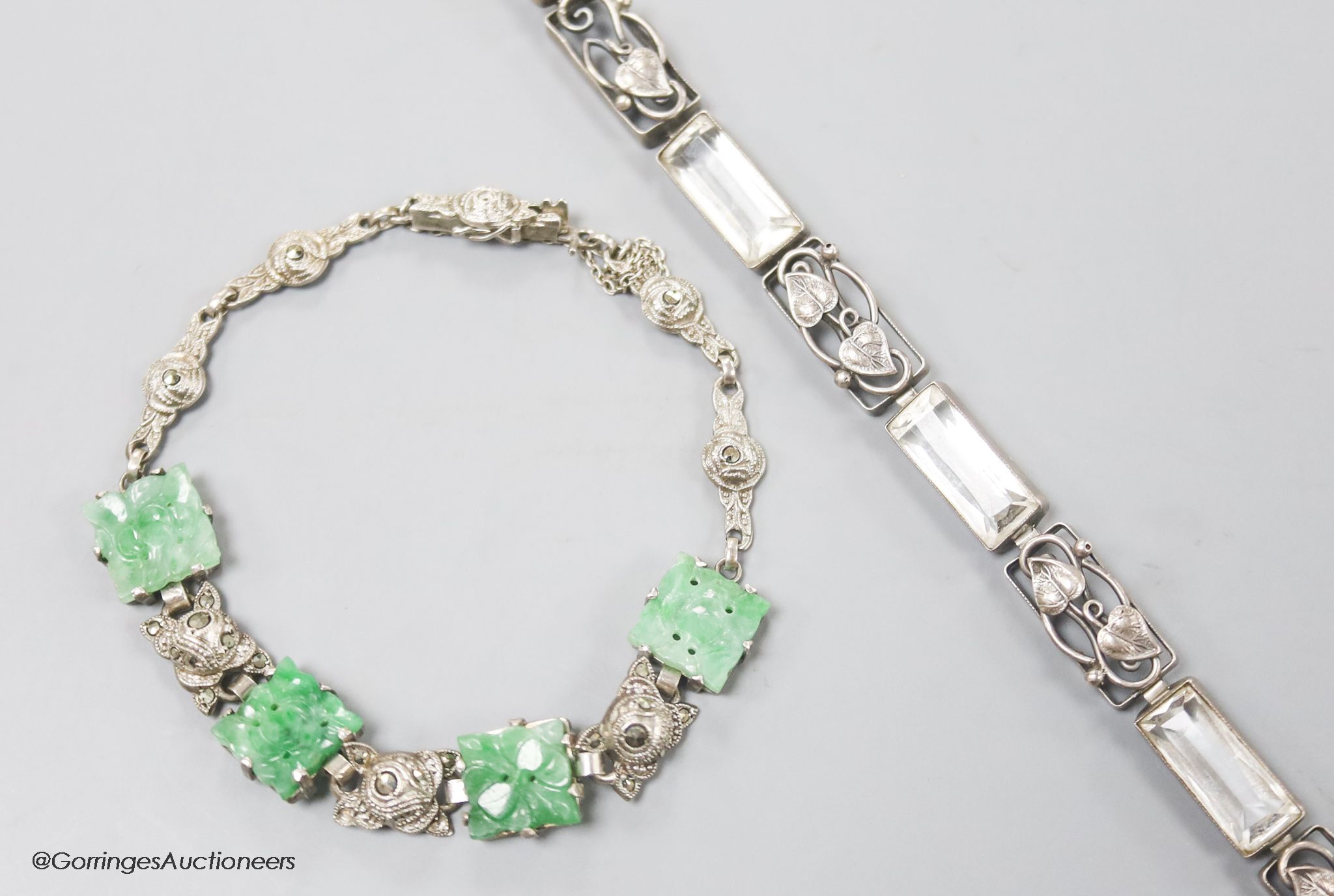 A white metal and carved jade set bracelet and one other bracelet.
